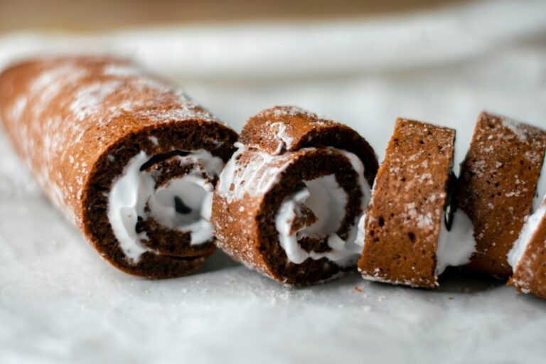 Chocolate swiss roll cake with white cream filling. Imagem ilustrativa para Bolo de Rolo de Chocolate com Cereja: Uma Sobremesa Sofisticada e Irresistível.